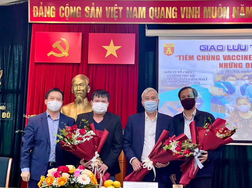 Tổng biên tập ANTĐ Nguyễn Thanh Bình (bìa trái) tặng hoa các khách mời tham gia giao lưu trực tuyến