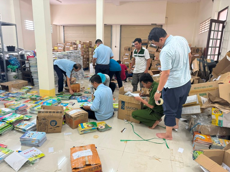Lực lượng chức năng kiểm đếm sách giả tại một cơ sở kinh doanh
