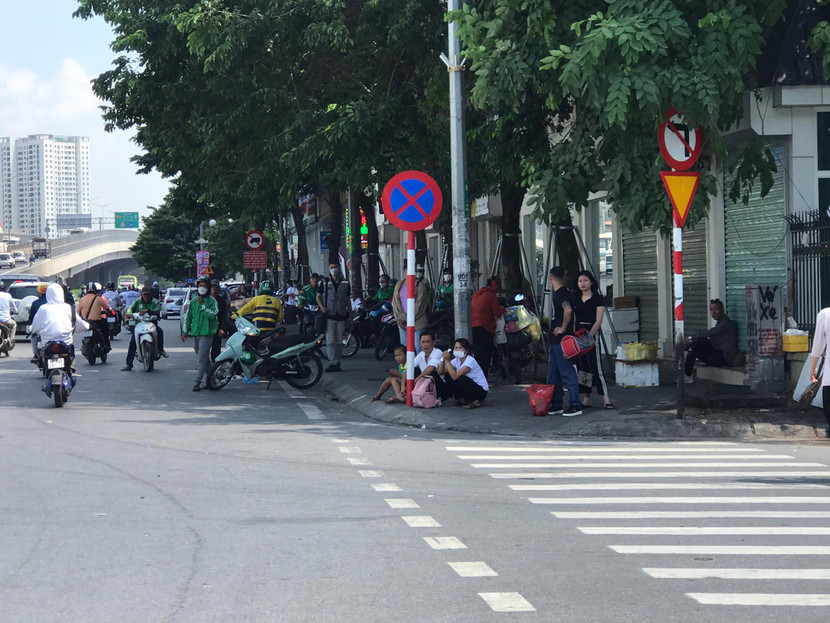 Hành khách kẻ ngồi, người đứng chờ xe dọc đường Hành khách kẻ ngồi, người đứng chờ xe dọc đường