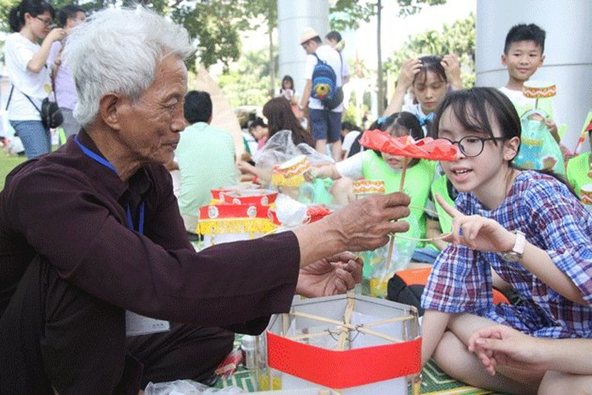 Các nghệ nhân hướng dẫn các em nhỏ làm đồ chơi dân gian Các nghệ nhân hướng dẫn các em nhỏ làm đồ chơi dân gian