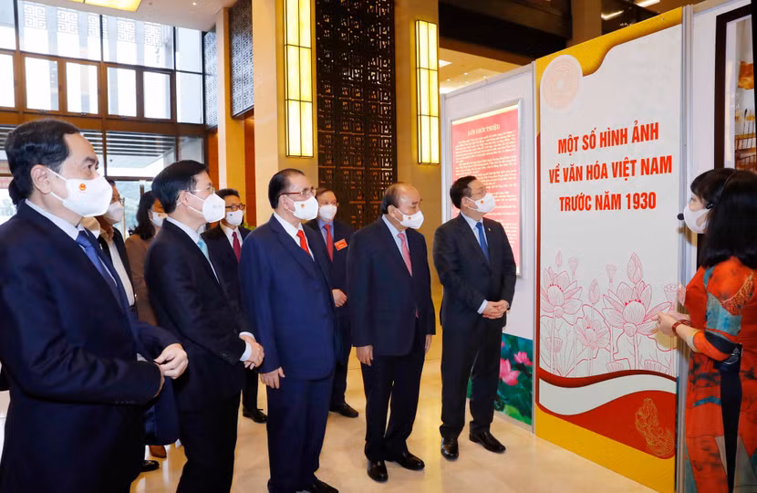 Các đồng chí lãnh đạo, nguyên lãnh đạo Đảng, Nhà nước và các đại biểu tham quan, nghe giới thiệu về Triển lãm “Văn hóa soi đường cho quốc dân đi”