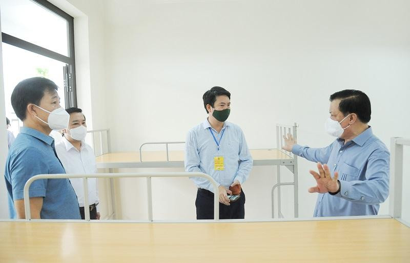 Bí thư Thành ủy kiểm tra bên trong một phòng chuẩn bị cho việc cách ly tại Trường Tiều học thị trấn Trạm Trôi