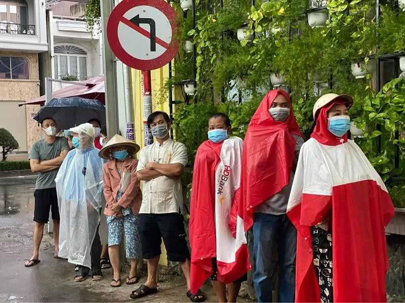 Người dân TP HCM đội mưa chờ lấy mẫu xét nghiệm