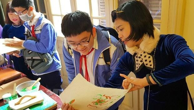 Các em học sinh làm thử tranh dân gian tại triển lãm Các em học sinh làm thử tranh dân gian tại triển lãm