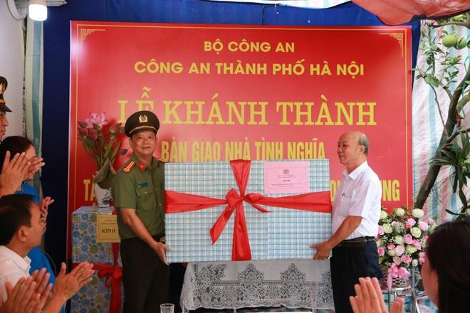 Đại tá Phạm Thanh Hùng - Phó Giám đốc CATP Hà Nội tặng quà đồng chí thương binh công an Nguyễn Quốc Xung trong ngày khánh thành, bàn giao Nhà tình nghĩa