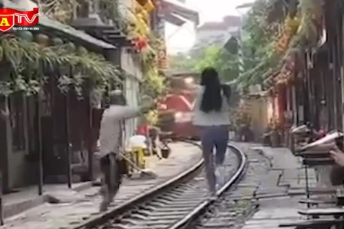 Thót tim khoảnh khắc cô gái lao ra giữa đường ray ngay khi tàu hỏa đến 