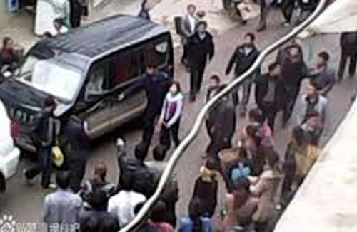 Lỡ đổ nước lên xe quan chức, bé gái bị còng tay diễu phố