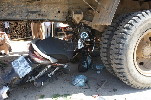 Xe máy chui vào gầm xe tải, 2 cha con thương vong
