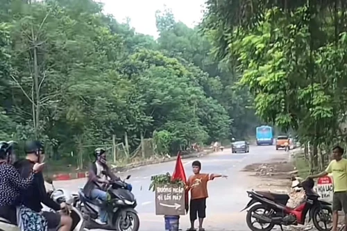 Nhiều lời khen ngợi cậu bé lớp 4 làm 'hoa tiêu' giúp người đi xe tránh ngập úng