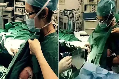 Xúc động cảnh nữ y tá dỗ bệnh nhi bú trước ca phẫu thuật