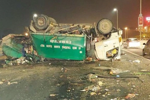 Nổ 2 lốp bên phải, xe chở rác lật úp trên cầu Nhật Tân 