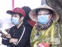 [ẢNH] Đề phòng mắc nCoV, du khách không rời khẩu trang y tế khi du xuân