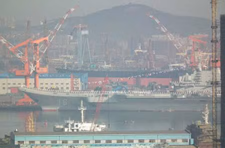 Boong tàu sân bay Liêu Ninh đang được chuẩn bị cho một buổi lễ gì đó, hình ảnh có độ phân giải không cao. Một số thiết bị phục vụ cho hội nghị ngoài trời đang được lắp đặt. Các nhân viên đang khẩn trương lắp đặt thiết bị phục vụ cho buổi lễ, còn buổi lễ gì thì còn phải chờ. Phần mũi tàu sân bay đầu tiên của Trung Quốc nhìn từ phía bên kia cầu cảng Đại Liên. Tàu sân bay được sơn số hiệu 16, trên boong tàu có 2 trực một trong 2 chiếc có vẻ là trực thăng không người lái mới. Ghế ngồi phục vụ cho khách mời đã được sắp sẵn trên boong tàu sân bay. Một lối đi có mái che đã được lắp đặt từ cầu cảng lên boong tàu, điều đó cho thấy đây là một buổi lễ quan trọng có sự chứng kiến của các quan chức cấp cao Trung Quốc.
