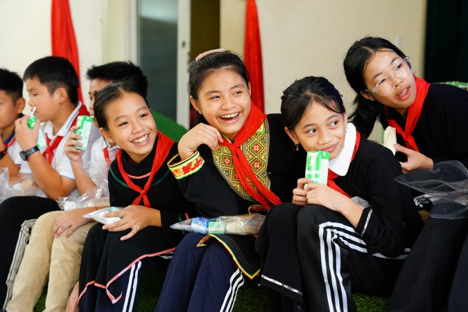 Nhận những phần quà gồm sữa tươi, sữa đặc của Vinamilk và bánh mì, các em đều hớn hở, vui thích vì đã có thể kịp đón Trung thu sau những ngày bão lũ