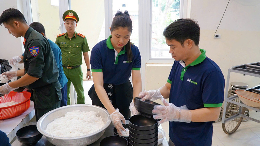 Các thành viên BellHome - thuộc Tập đoàn Bell cùng chiến sĩ Công an và nhóm thiện nguyện chung tay chuẩn bị những bát phở gà nóng hổi gửi tặng các nạn nhân da cam tại Trung tâm
