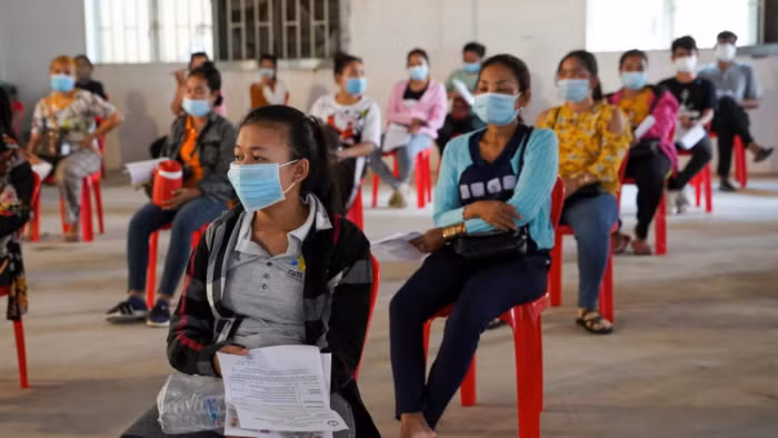 Công nhân chờ tiêm vaccine ngừa Covid-19 tại một khu công nghiệp ở Thủ đô Phnom Penh