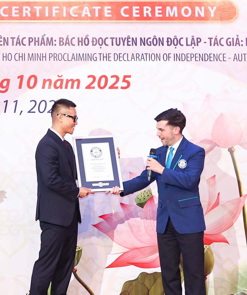 Ông Austin Johnson, Giám định viên chính thức của Tổ chức Kỷ lục Guinness thế giới trao chứng nhận "Bức tranh sơn mài liền khối lớn nhất" cho hoạ sĩ Chu Nhật Quang