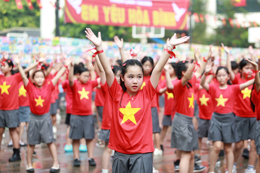Trong sắc màu rực rỡ cờ đỏ sao vàng trên áo của học sinh tung bay theo từng bước múa, từng câu hát