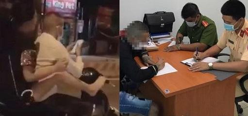 Hình ảnh đôi nam nữ dùng chân lái xe máy gây nguy hiểm cho người tham gia giao thông