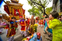 Không khí linh thiêng khi kiệu Thánh đi qua. Người dân chắp tay thành kính bái vọng, trong khi nhịp trống hội tiếp tục thúc giục bước chân dồn dập của các "phụ giá".