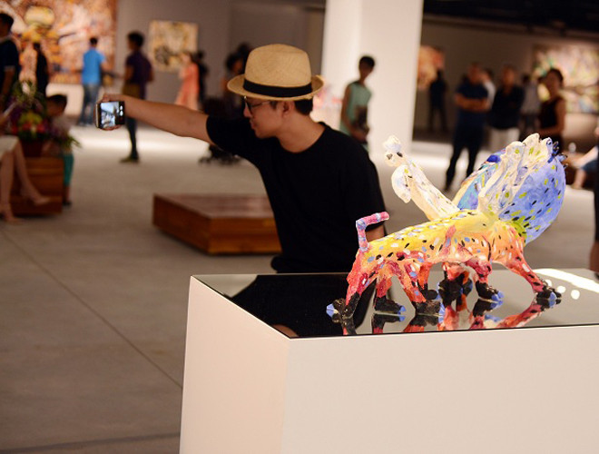 Khách tham quan không “cưỡng” được sự thích thú với các tác phẩm độc đáo của họa sĩ Lê Kinh Tài.