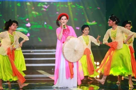 Phi Nhung mặc áo tứ thân, đội nón quai thao thị phạm cho thí sinh