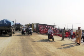 Xe tải bị lật, hàng trăm két bia tràn xuống đường