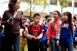 Học sinh Hà Nội đi học trở lại sau một ngày nghỉ tránh bão