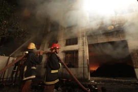 Cháy nhà máy may, 124 người chết 