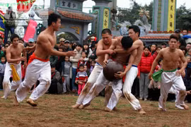 Trai tráng ở trần đua sức vóc với trái cầu sơn son
