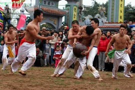 Trai tráng ở trần đua sức vóc với trái cầu sơn son