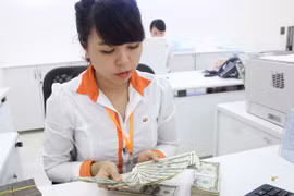 Thị trường bình tĩnh đón nhận cơ chế điều hành tỷ giá lên-xuống hàng ngày
