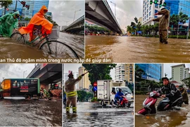 Hình ảnh chiến sỹ Công an Thủ đô ngâm mình trong nước ngập để giúp dân