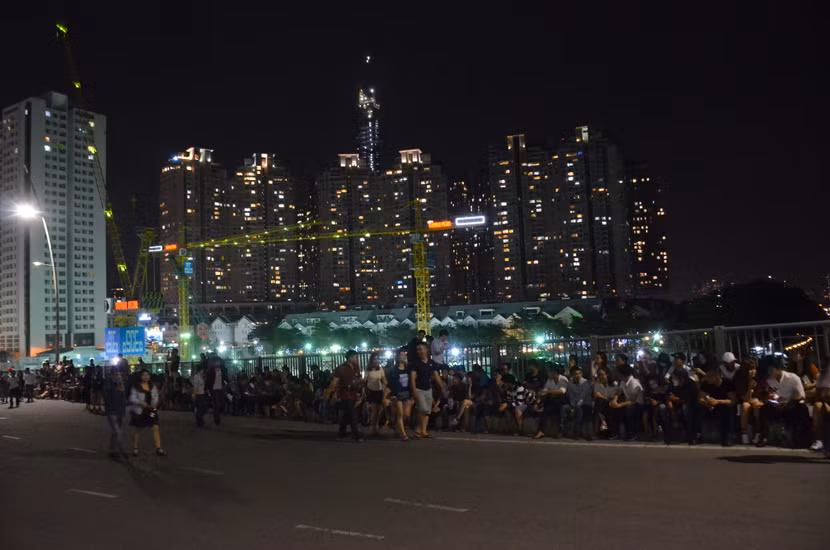 Người dân TP.HCM đi bộ xếp hàng dài tập trung trên cầu Thủ Thiêm để chờ bắn pháo hoa chào đón năm mới.